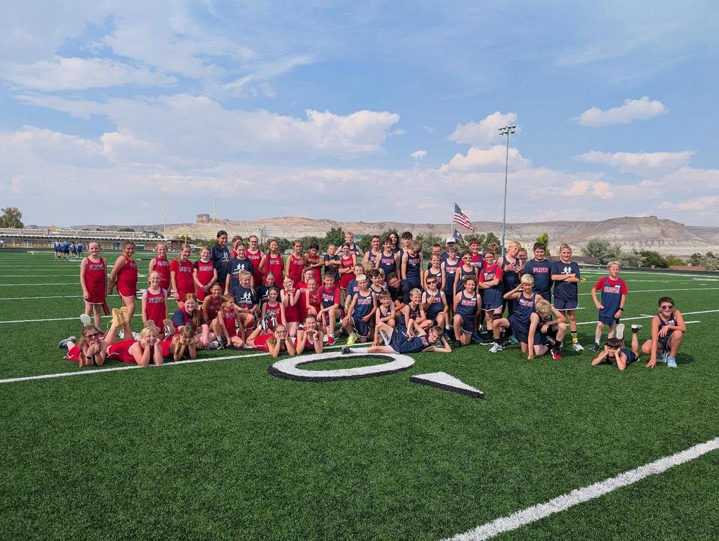 Track team in group photo on football field